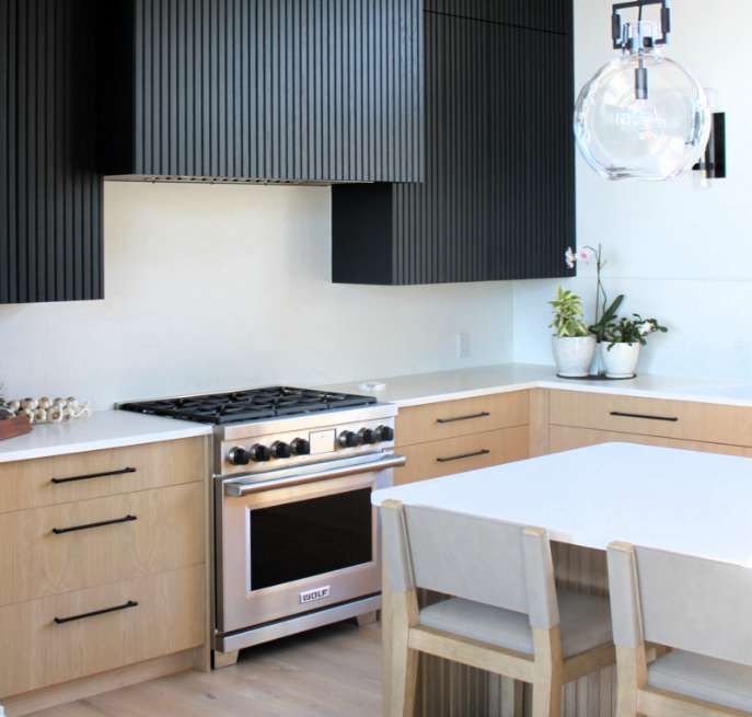 Modern kitchen with black fluted cabinets designed by an Ottawa kitchen cabinet manufacture expert.