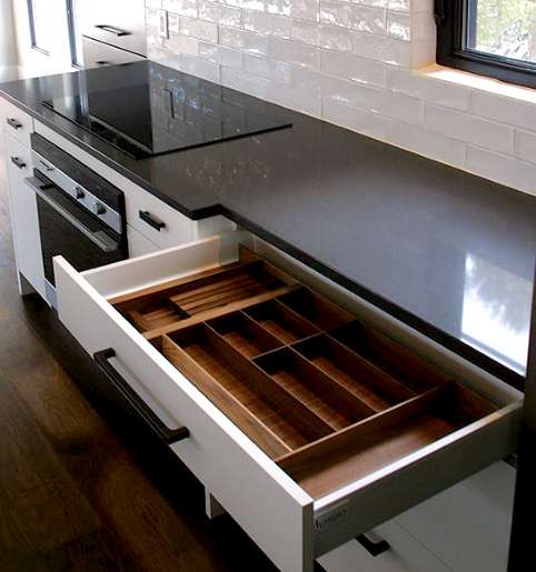 A custom walnut wood drawer organizer crafted by a professional Ottawa kitchen cabinet manufacturer.