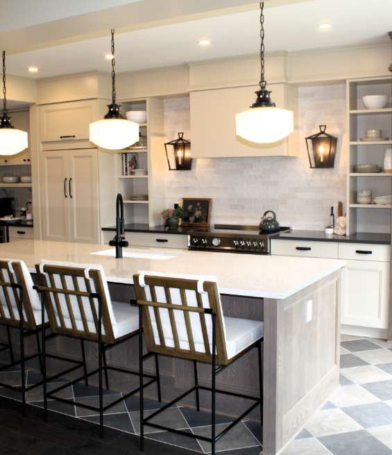 Modern white kitchen with a large island featuring custom cabinets by Muskoka Cabinet Company.