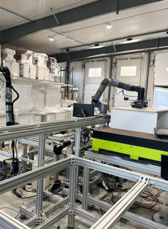 Robotic arm assembly line inside a high-tech custom cabinet manufacturing facility in Ontario.